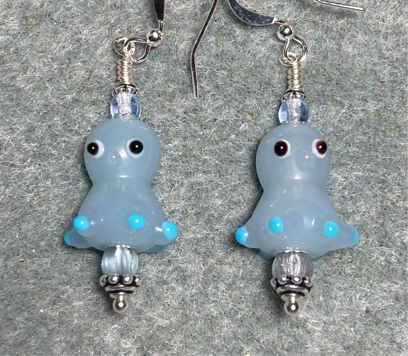 Light blue lamp work octopus bead earrings adorned with light blue Czech glass beads.