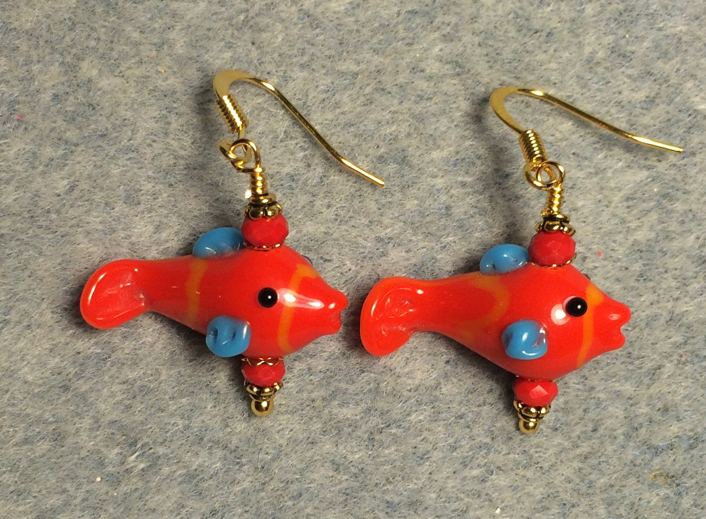 Small red and blue lamp work fish bead earrings adorned with red Chinese crystal beads.