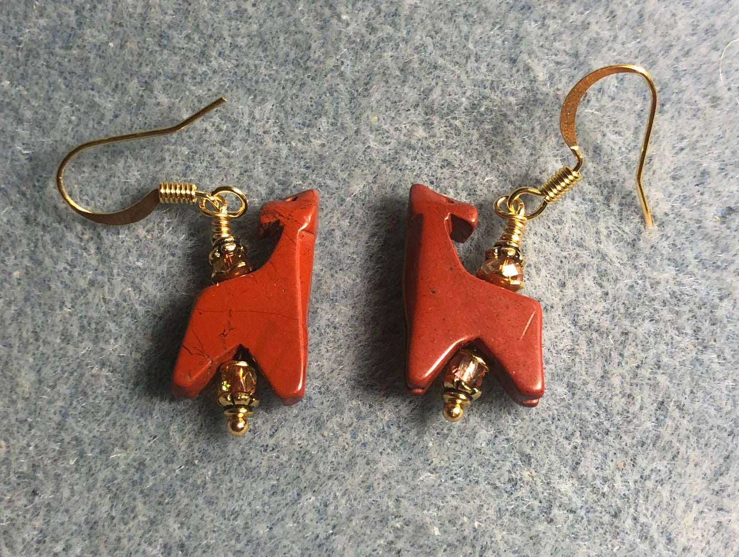 Red poppy jasper gemstone howling wolf bead earrings adorned with orange red Chinese crystal beads.