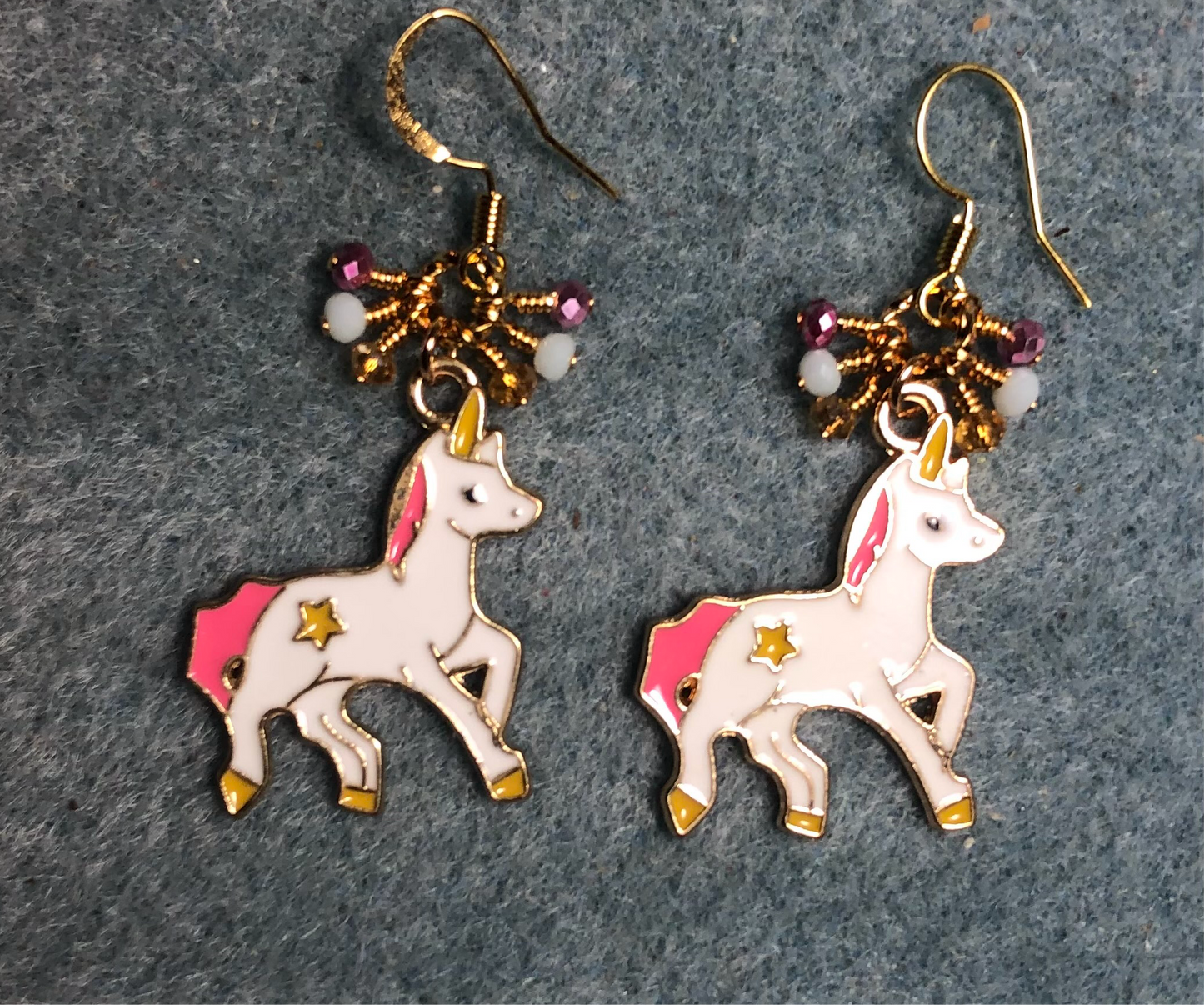Pink, white, and yellow enamel unicorn charm earrings adorned with tiny dangling pink, white, and yellow Chinese crystal beads.