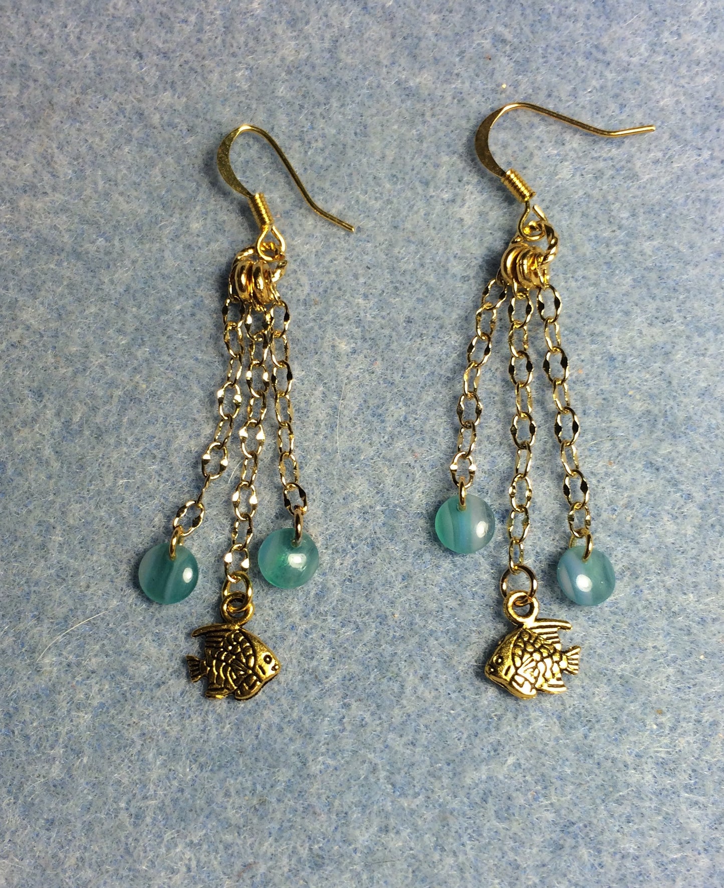 Gold angelfish charm earrings attached to gold chain and adorned with turquoise Czech glass lentil beads.