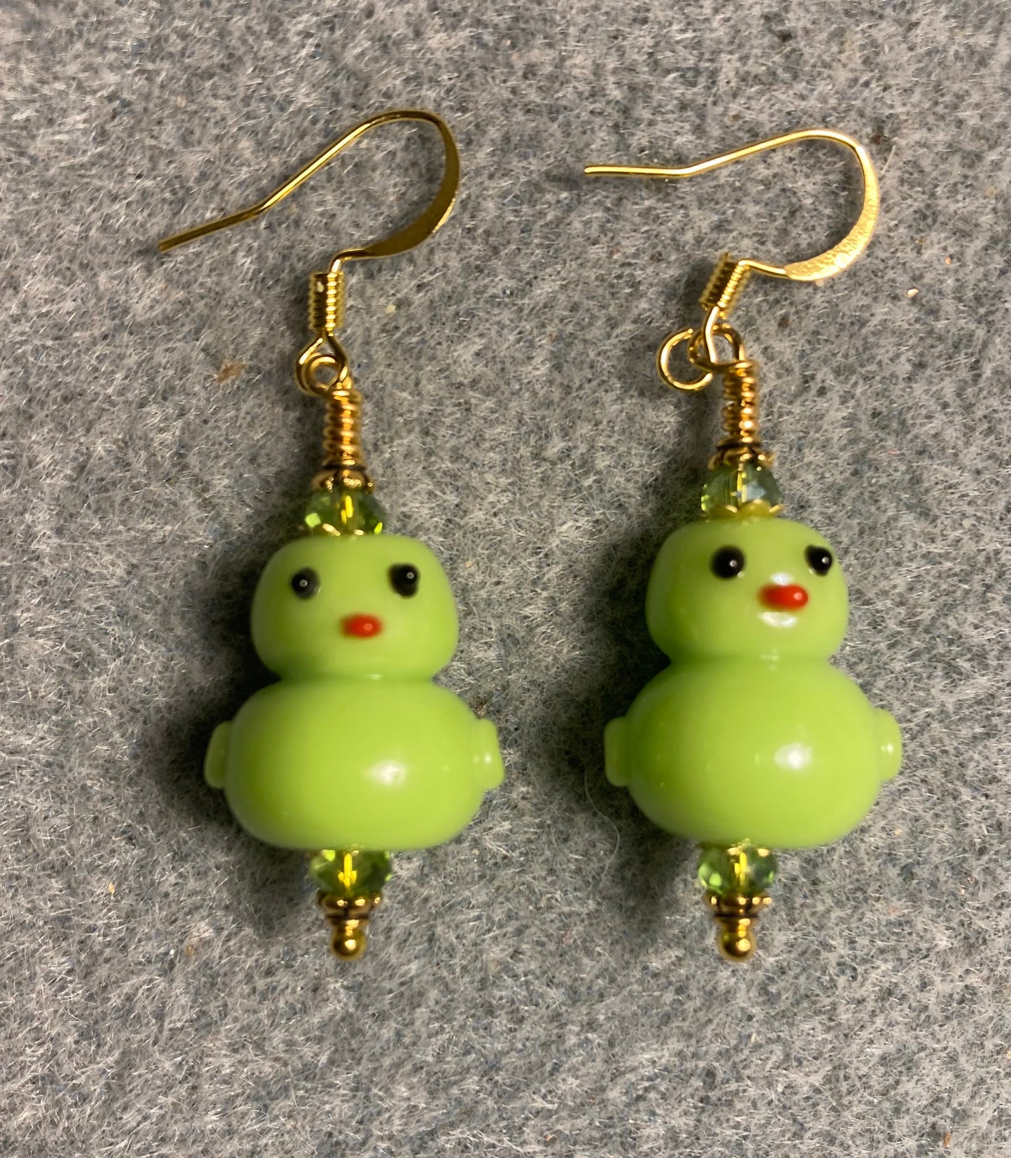 Olive green lamp work duck bead earrings adorned with olive green Chinese crystal beads.