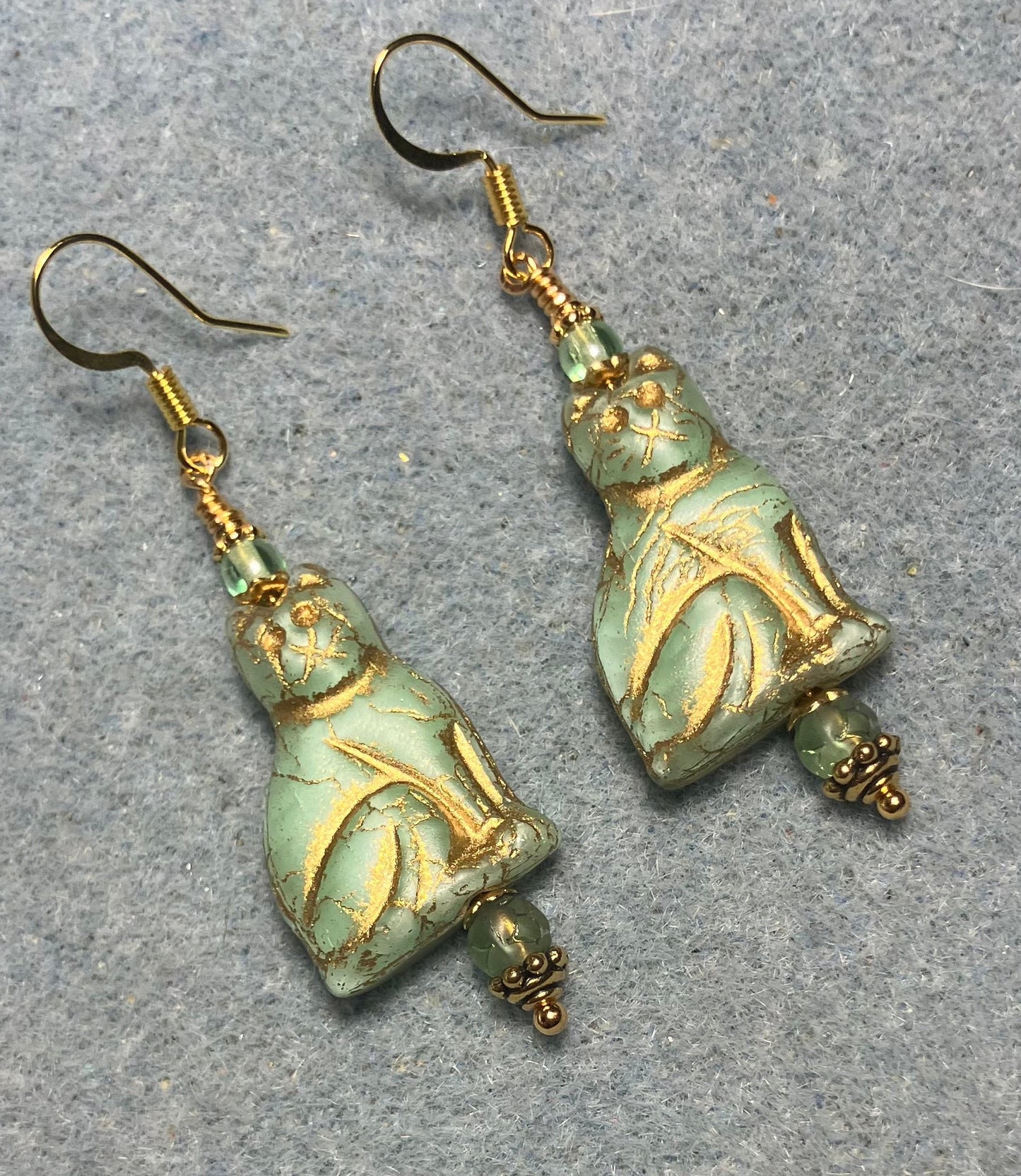 Light green (with gold inlay) Czech glass cat bead earrings adorned with light green Czech glass beads.