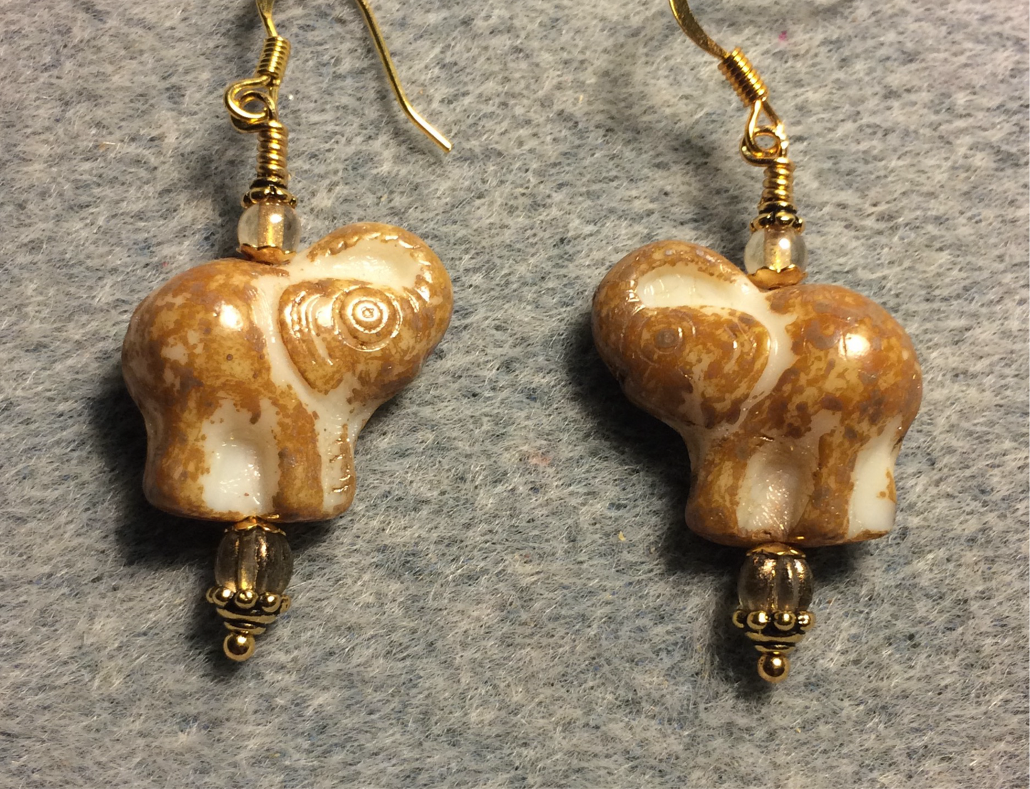 Tan (with cream inlay) Czech glass elephant bead earrings adorned with tan Czech glass beads.