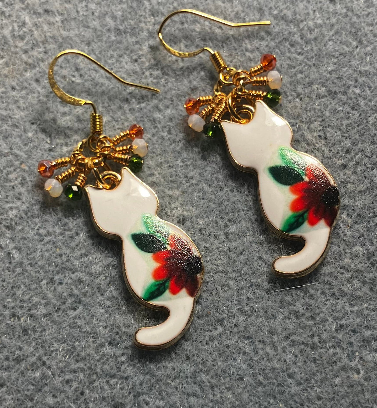 White, orange, and green enamel cat charm earrings adorned with tiny dangling white, orange, and green Chinese crystal beads.