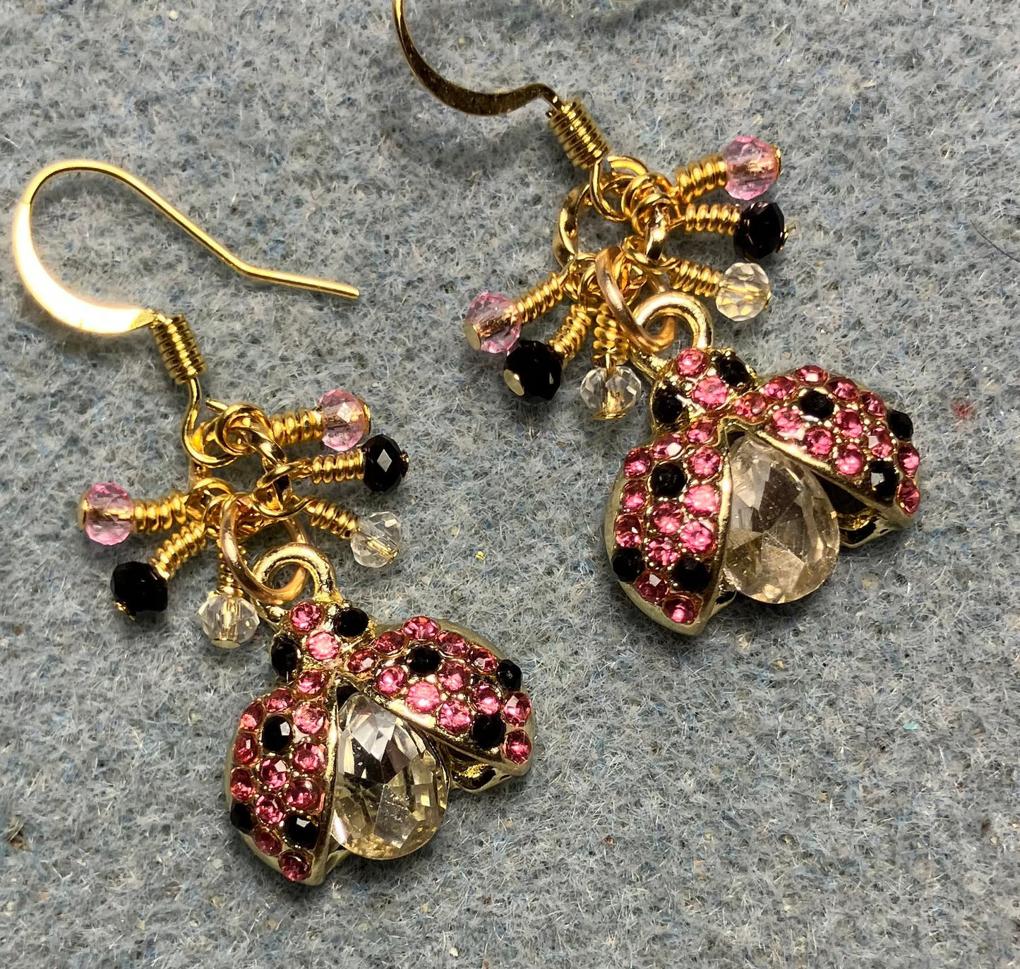 Pink, black, and clear enamel and rhinestone ladybug charm earrings adorned with tiny dangling pink, black, and clear Chinese crystal beads.