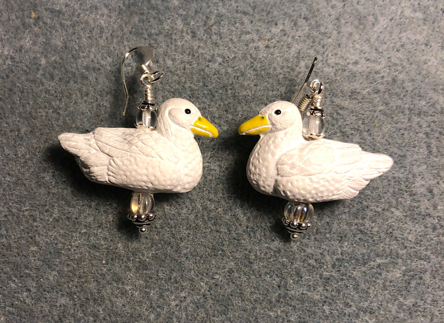 White ceramic duck bead earrings adorned with clear Czech glass beads.