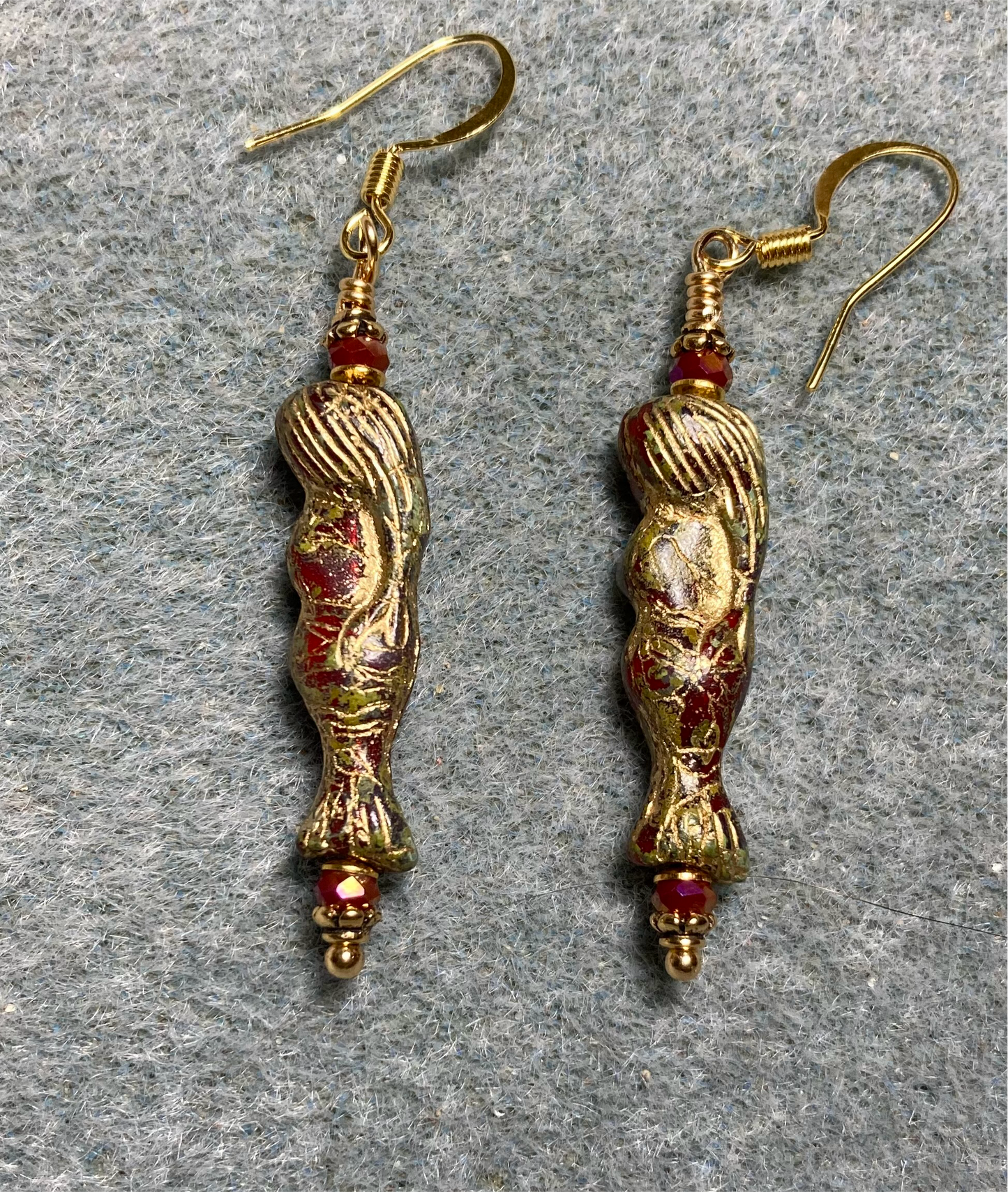 Dark red (with gold inlay) Czech glass mermaid bead earrings adorned with dark red Chinese crystal beads.