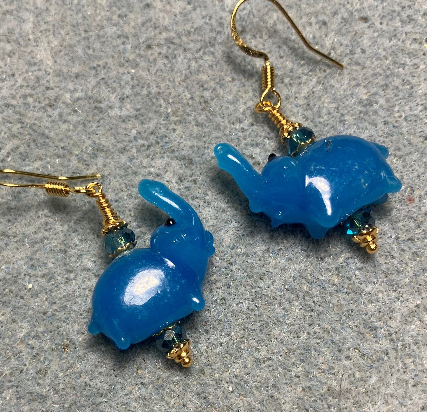 Small turquoise blue lamp work elephant bead earrings adorned with turquoise Chinese crystal beads.