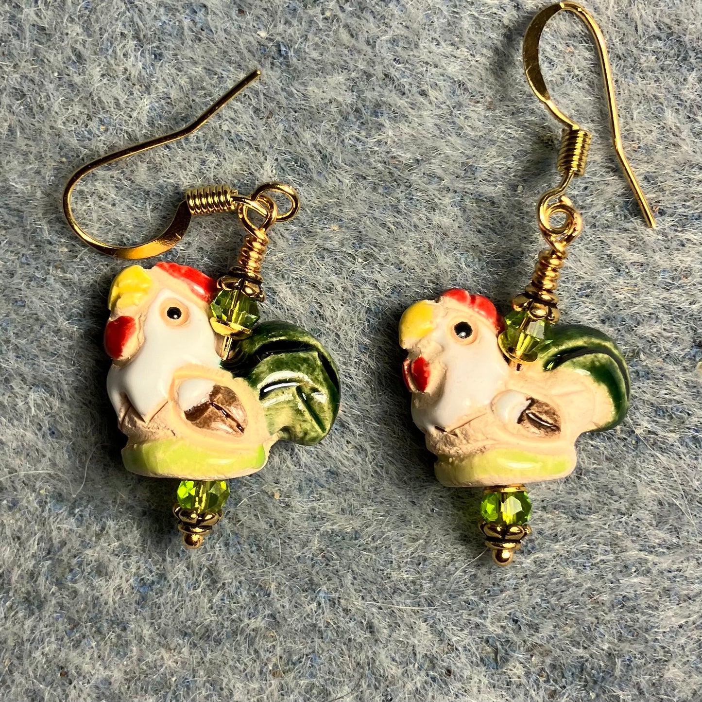 Small olive green, red, snd yellow ceramic chicken bead earrings adorned with olive green Chinese crystal beads.