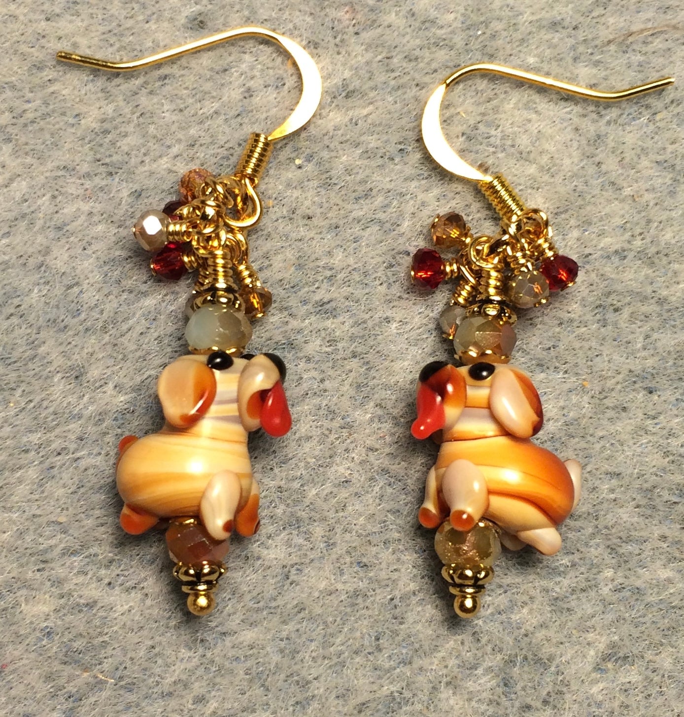 Tiny tan lamp work puppy dog bead earrings adorned with tan Chinese crystal beads and tiny dangling tan, red, and amber Chinese crystal beads.