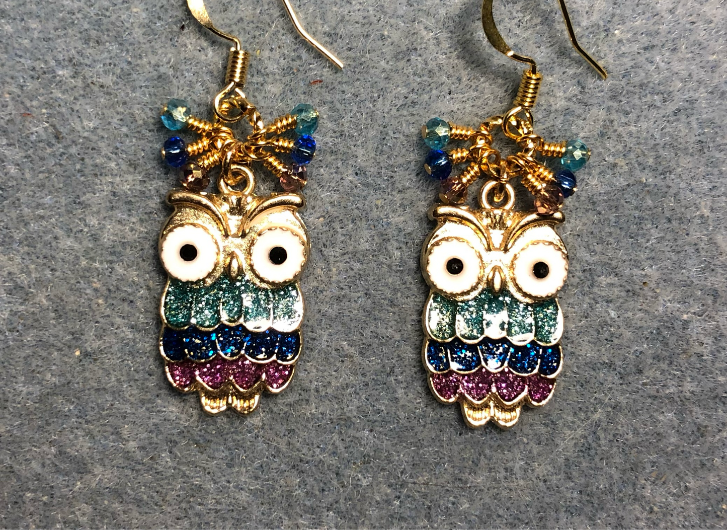 Purple, dark blue, and aqua enamel glittery owl charm earrings adorned with tiny dangling purple, dark blue, and aqua Chinese crystal beads.