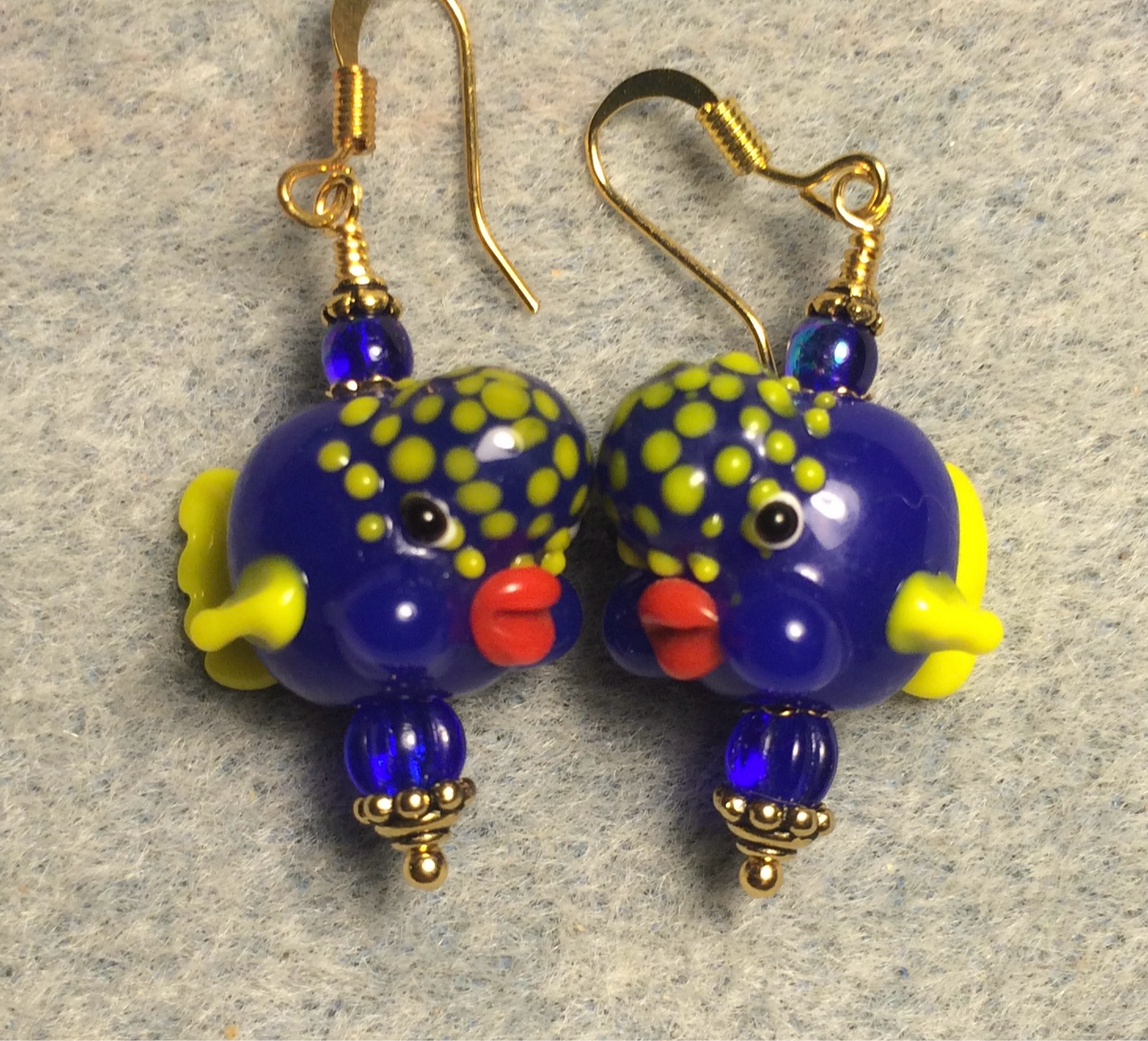 Opaque bright blue and yellow lamp work clownfish bead earrings adorned with bright blue Czech glass beads.