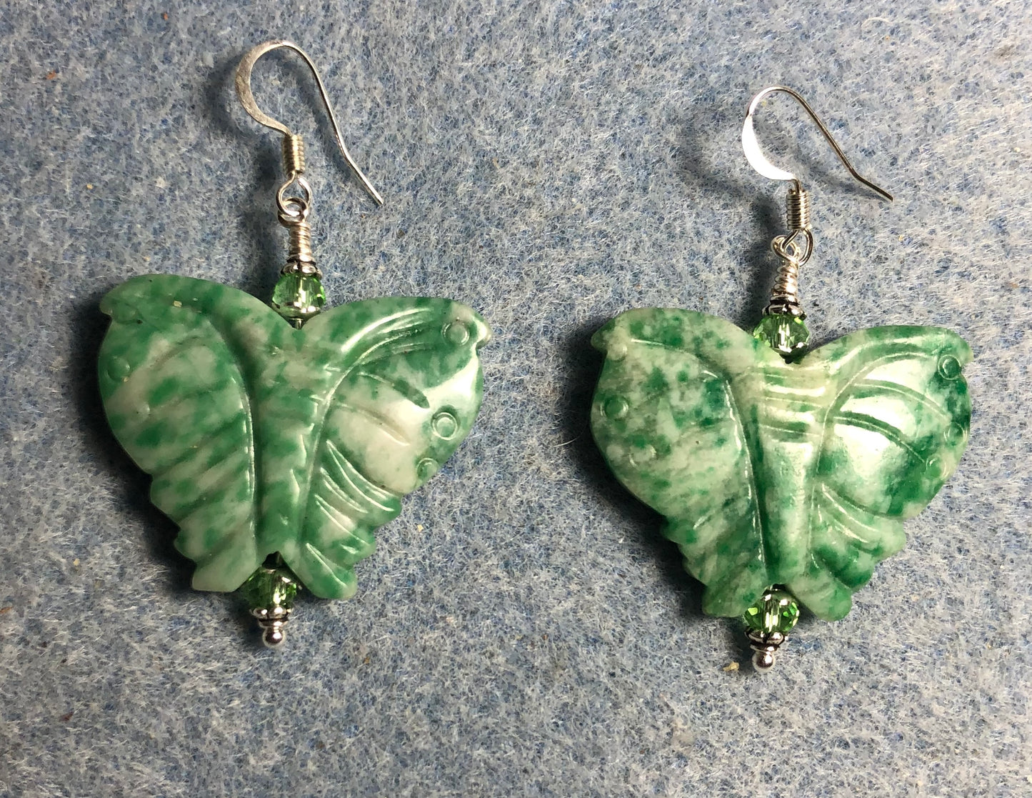 Large grass agate gemstone butterfly bead earrings adorned with green Chinese crystal beads.