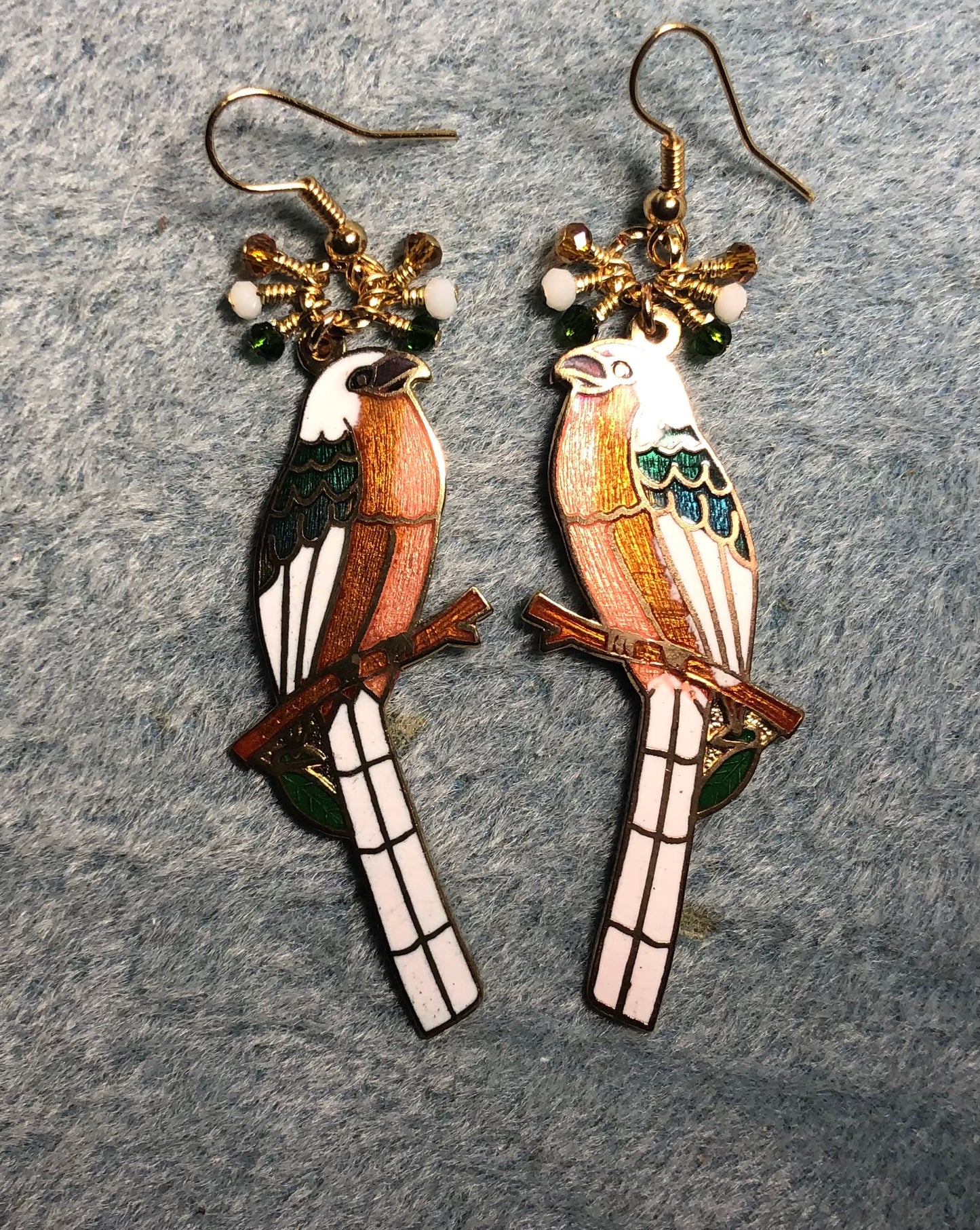 Long vintage amber, white, and green cloisonné songbird charm earrings adorned with tiny dangling amber, white, and green Chinese crystal beads.