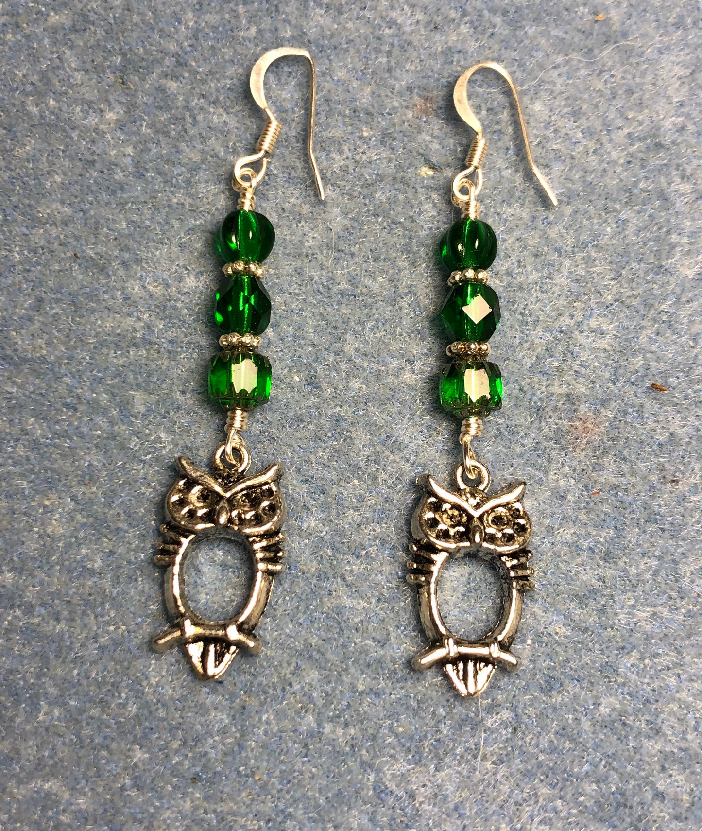 Small silver owl charm earrings adorned with emerald green Czech glass beads
