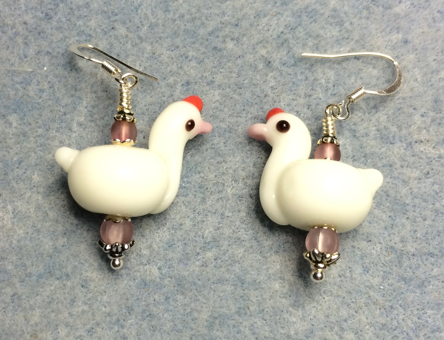 White and pink lamp work swan bead earrings adorned with pink Czech glass beads.