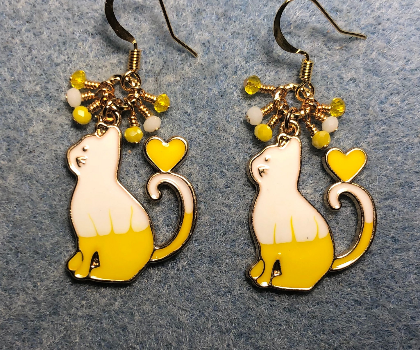 Yellow and white enamel cat charm earrings adorned with tiny dangling yellow and white Chinese crystal beads.