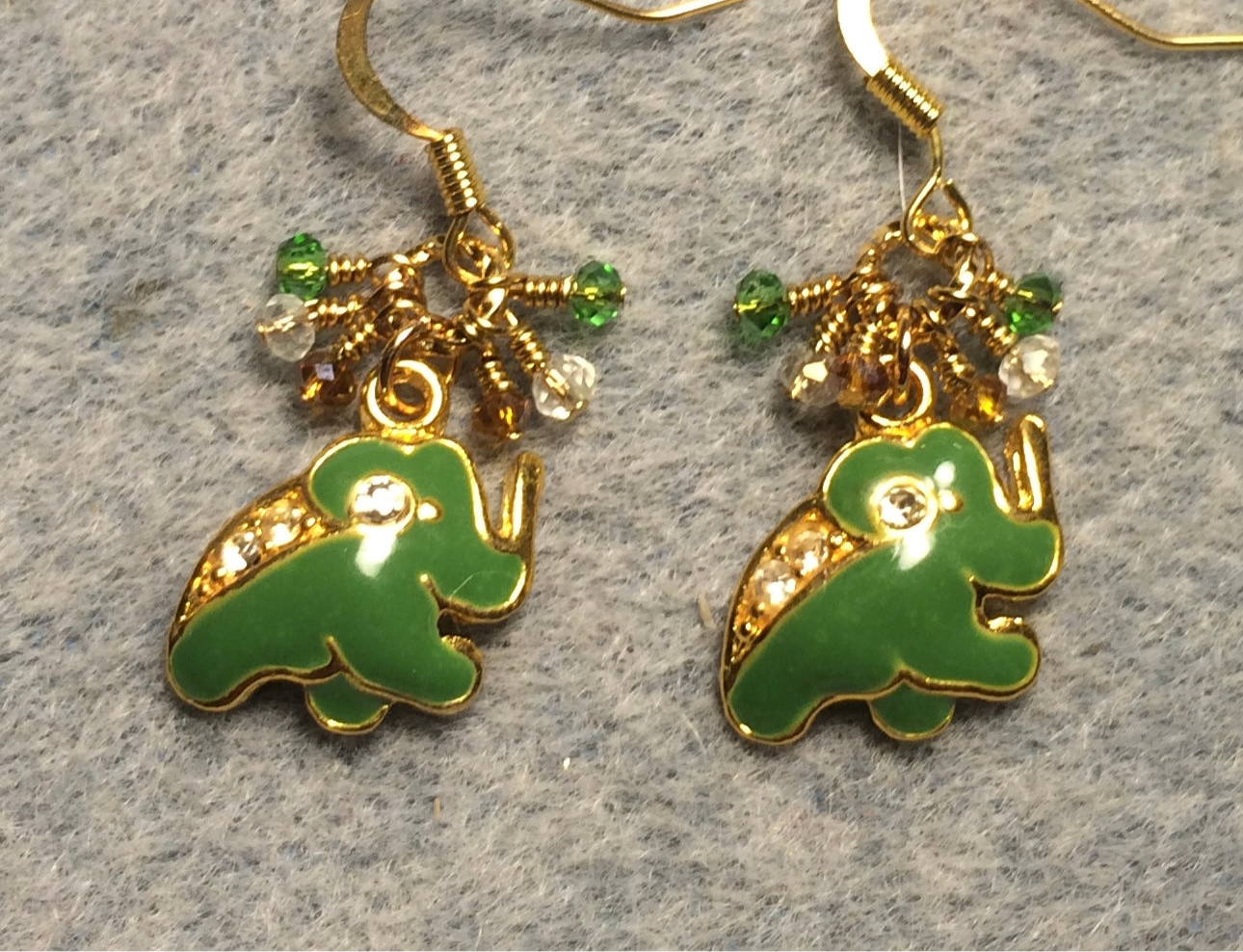 Vintage green enamel and rhinestone elephant charm earrings adorned with tiny dangling green, clear, and gold Chinese crystal beads.