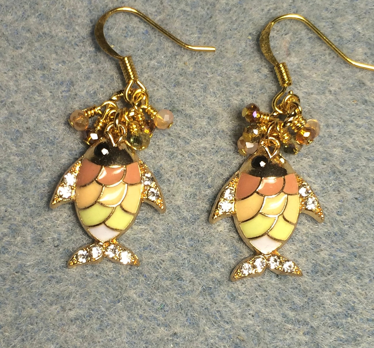 Pink, peach, and green enamel fish charm earrings adorned with tiny dangling pink, peach, and green Chinese crystal beads.