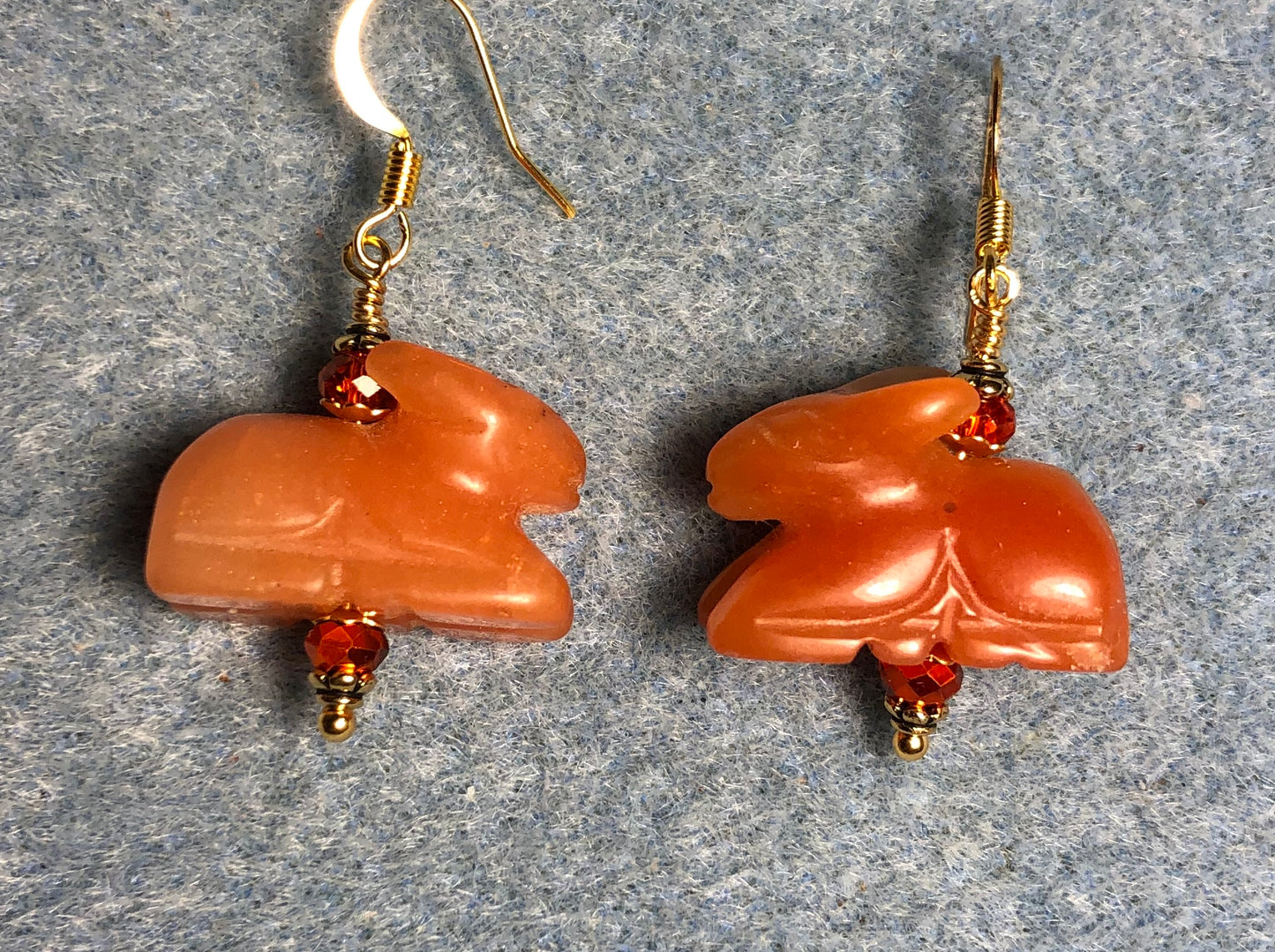 Carnelian gemstone rabbit bead earrings adorned with orange Chinese crystal beads.