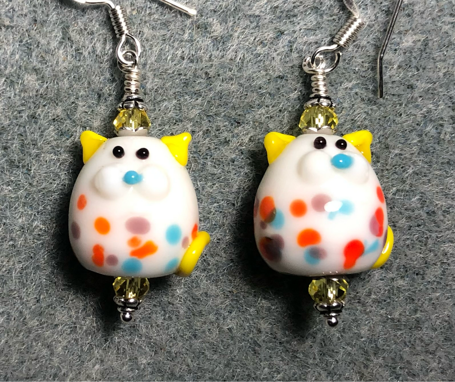 Whimsical colorful lamp work polka dot cat bead earrings adorned with yellow Chinese crystal beads.