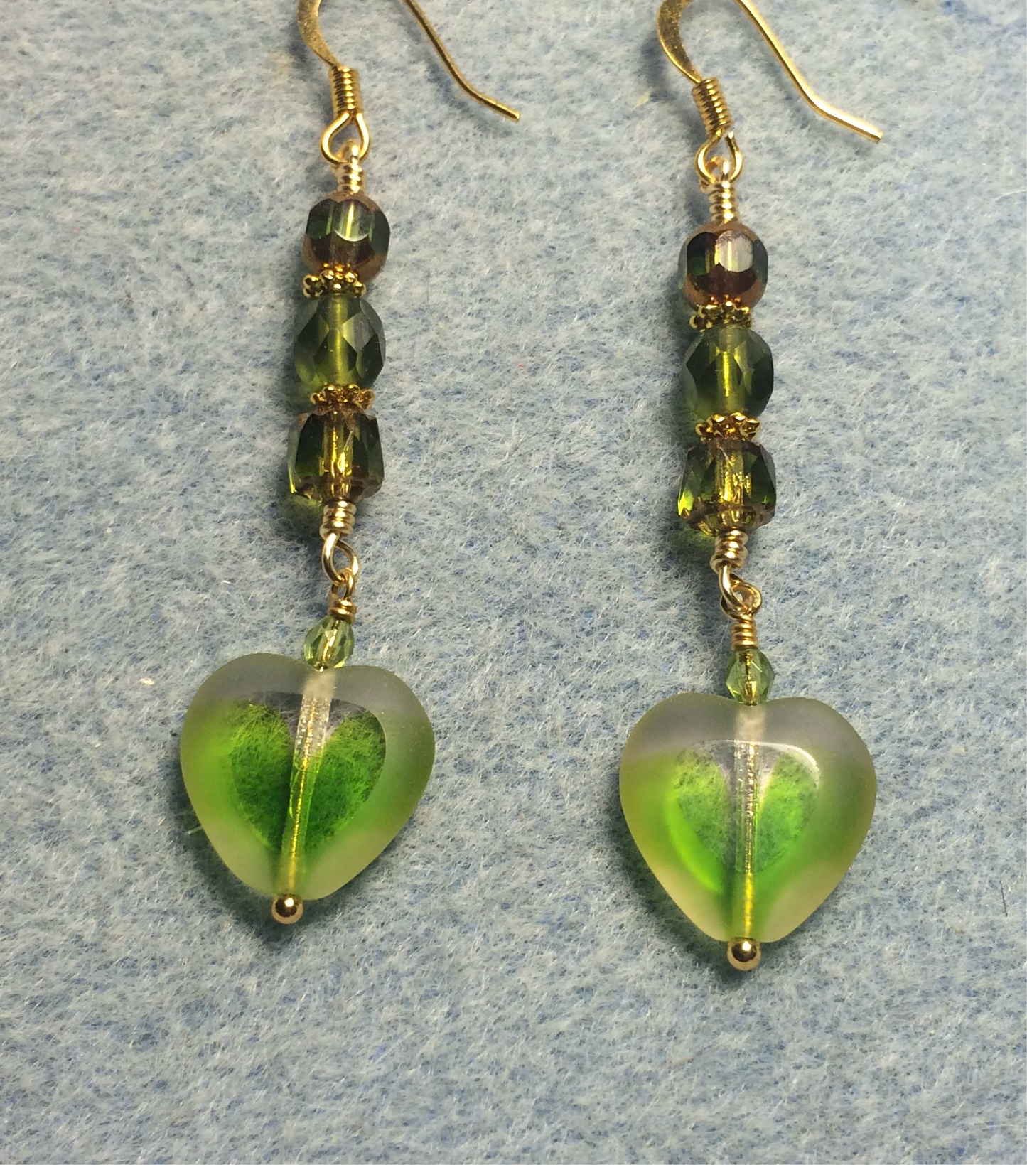 Olive green Czech glass heart bead earrings adorned with olive green Czech glass beads.