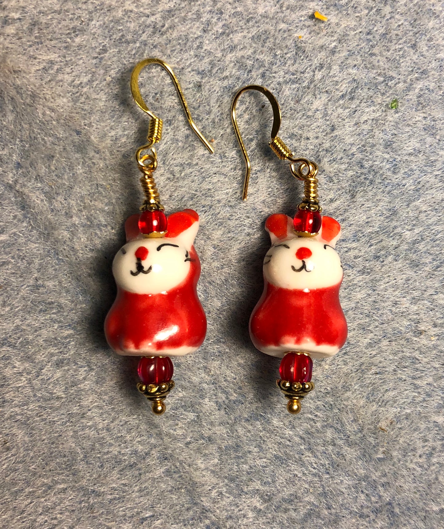 Red and white ceramic bunny rabbit bead earrings adorned with red Czech glass beads.
