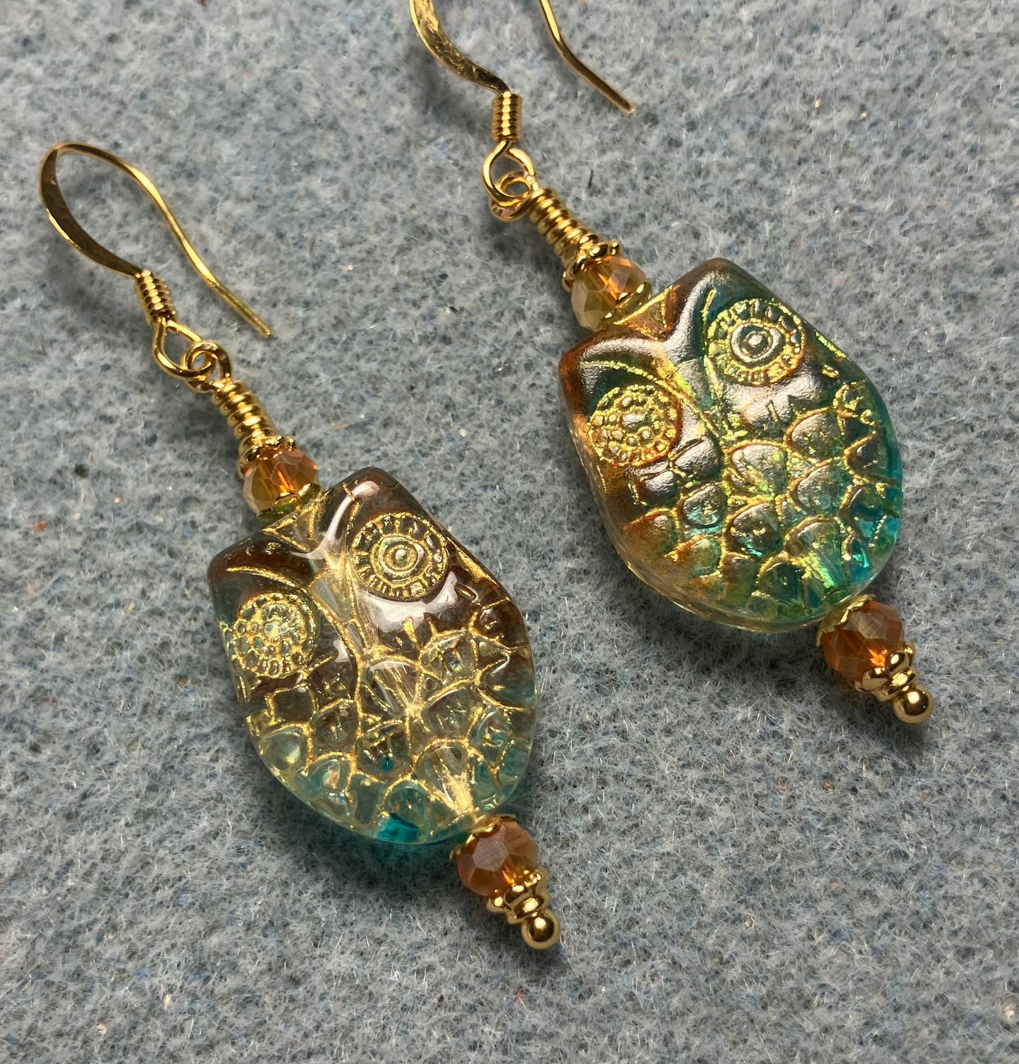 Sparkly green and orange (with gold wash) Czech glass owl bead earrings adorned with orange Chinese crystal beads.