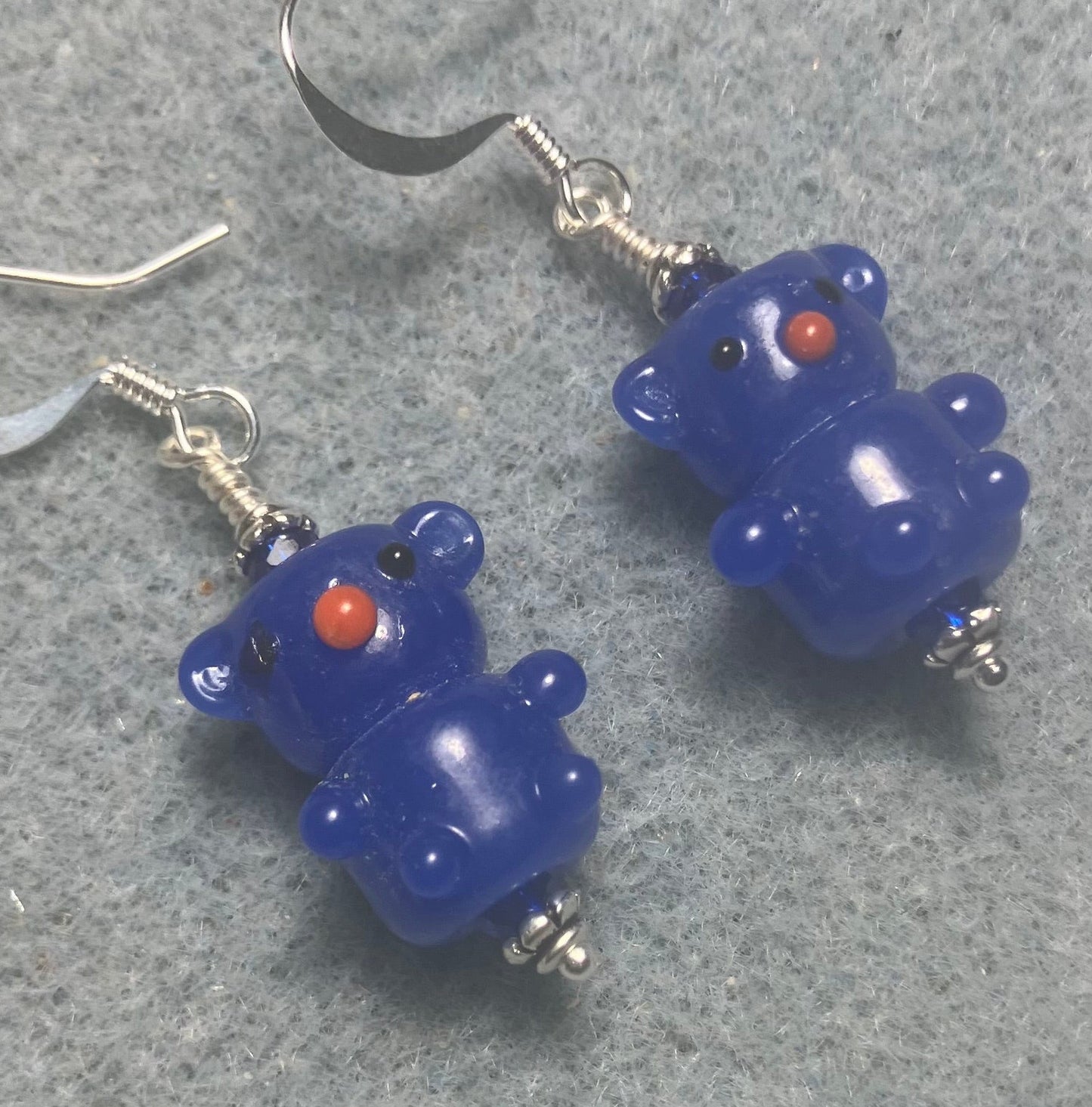 Small dark blue lamp work teddy bear bead earrings adorned with dark blue Chinese crystal beads.