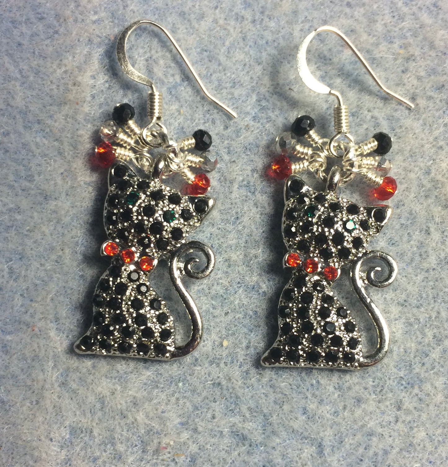 Black and red rhinestone cat charm earrings adorned with small dangling silver, black, and red Chinese crystal beads.