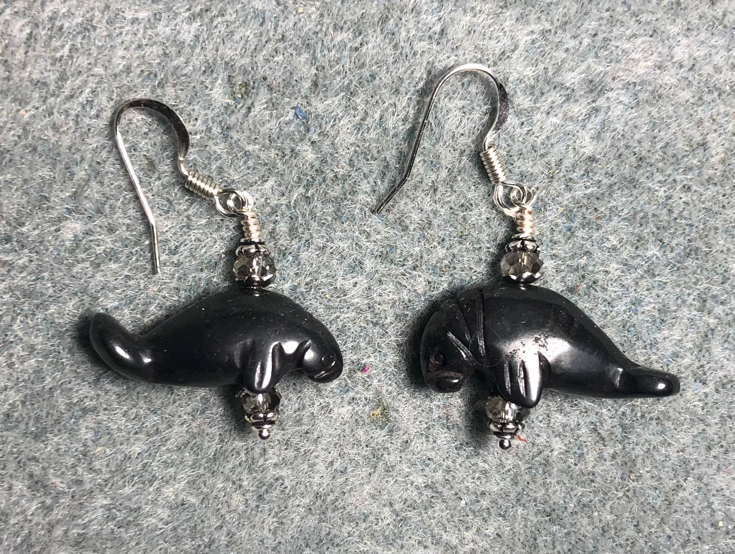 Gray hematite gemstone manatee bead earrings adorned with gray Chinese crystal beads.