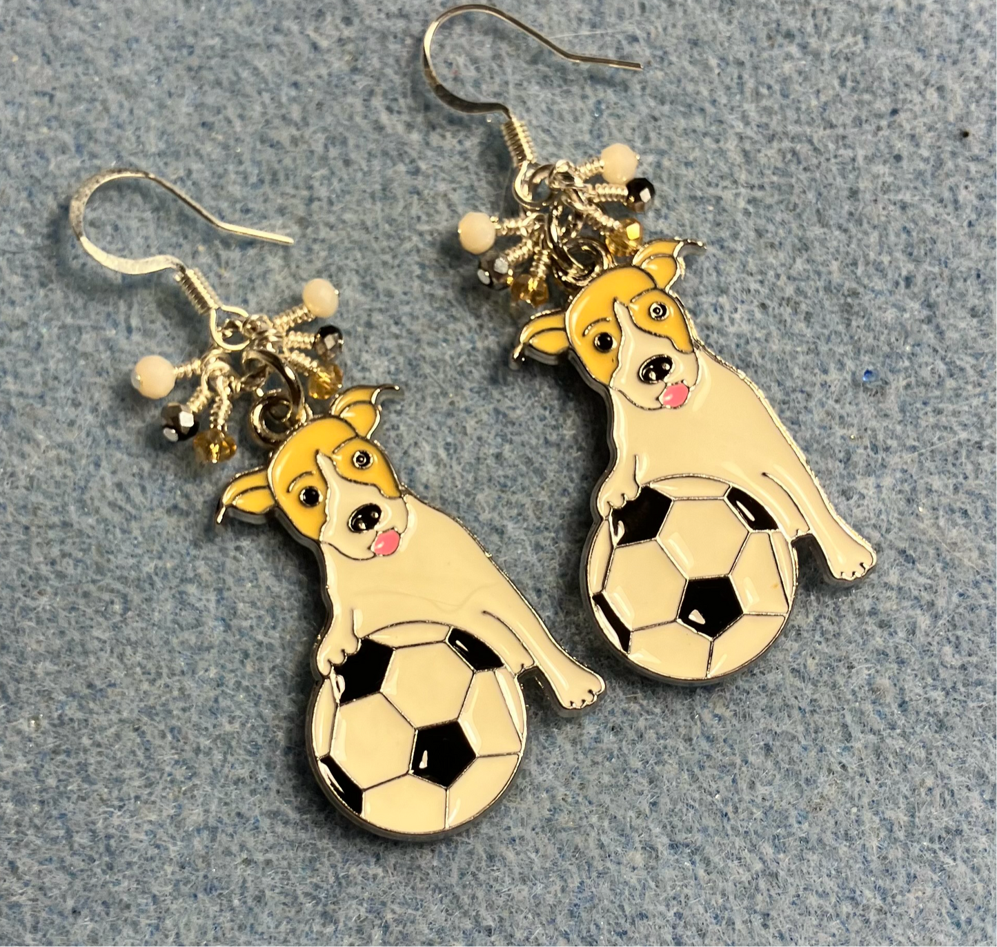 Tan and white enamel Jack Russell terrier (holding a soccer ball) charm earrings adorned with tiny dangling tan, white, and black Chinese crystal beads.