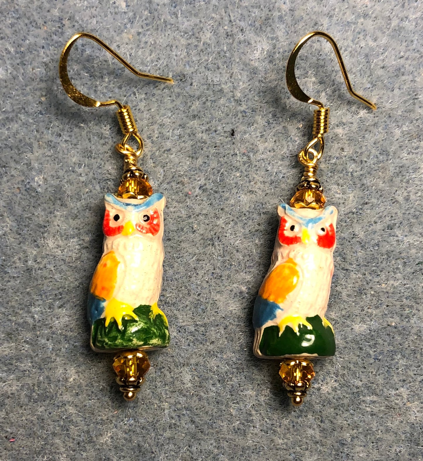 Small tan, orange, and green ceramic owl bead earrings adorned with tangerine Chinese crystal beads.