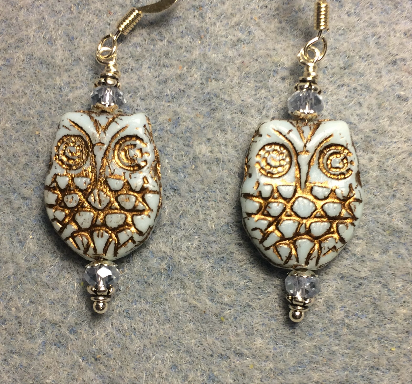 Light blue (with gold wash) Czech glass owl bead earrings adorned with light blue Chinese crystal beads.