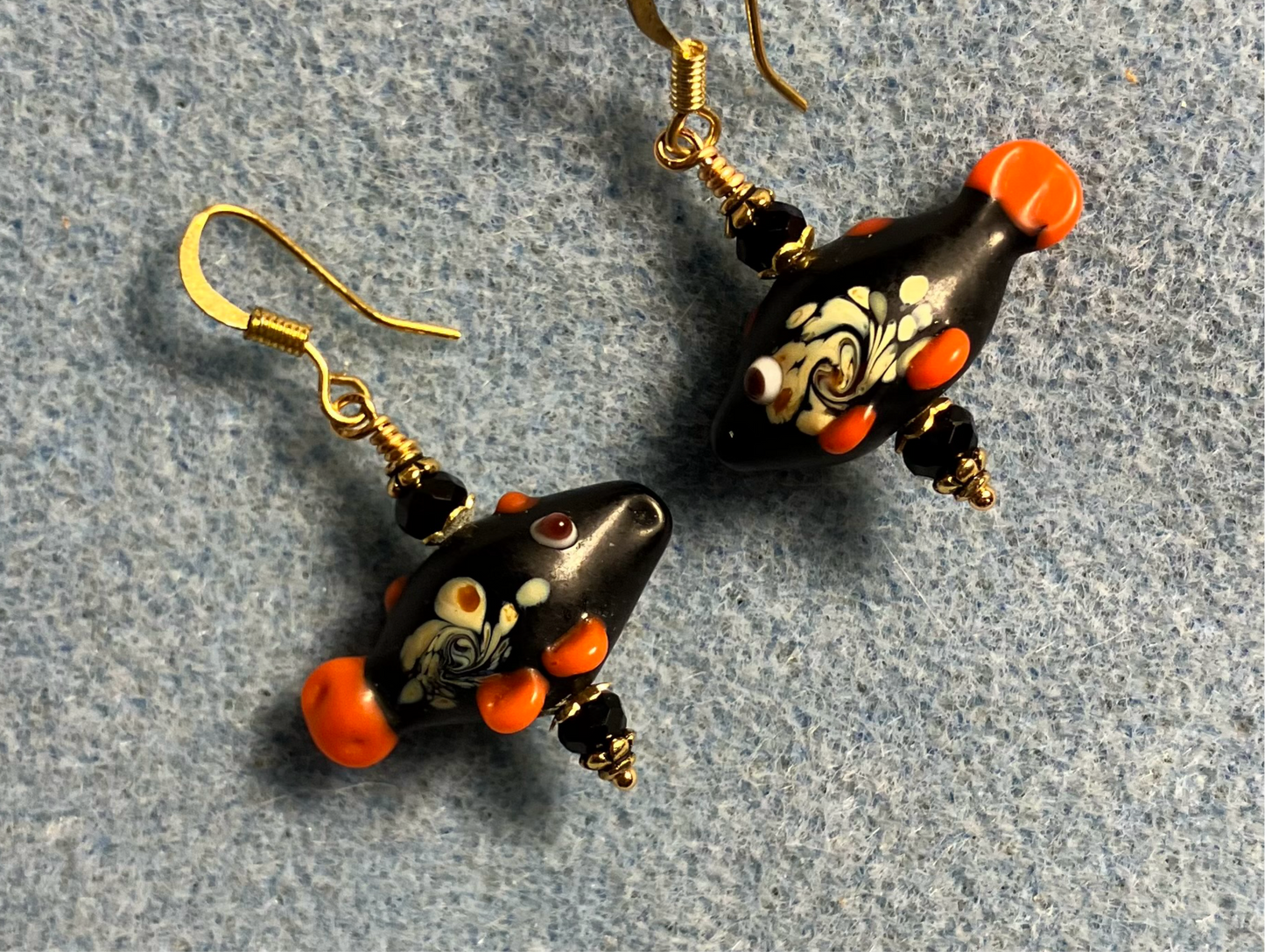 Black lamp work fish bead earrings adorned with black Chinese crystal beads.
