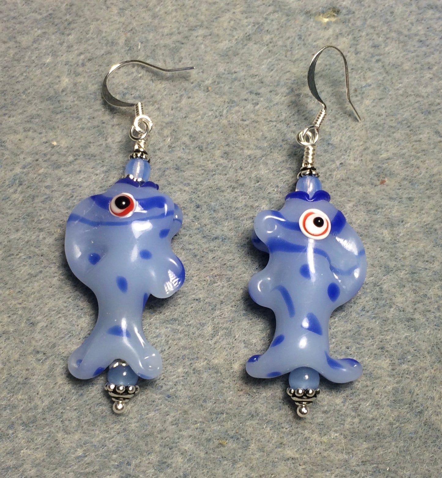 Milky light blue lamp work spotted fish bead earrings adorned with light blue Czech glass beads.