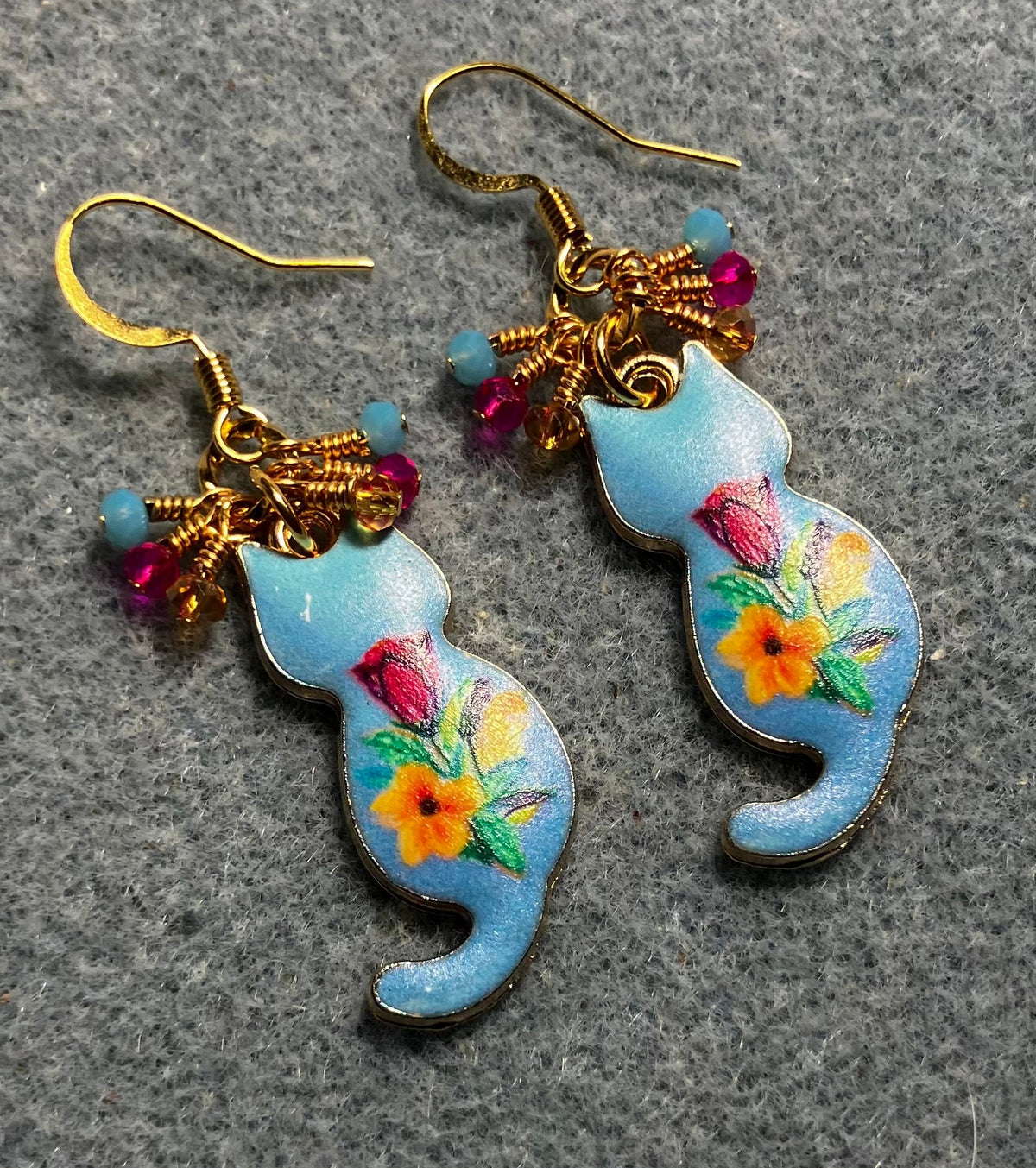 Light blue, hot pink, and amber enamel cat charm earrings adorned with tiny dangling light blue, hot pink, and amber Chinese crystal beads.