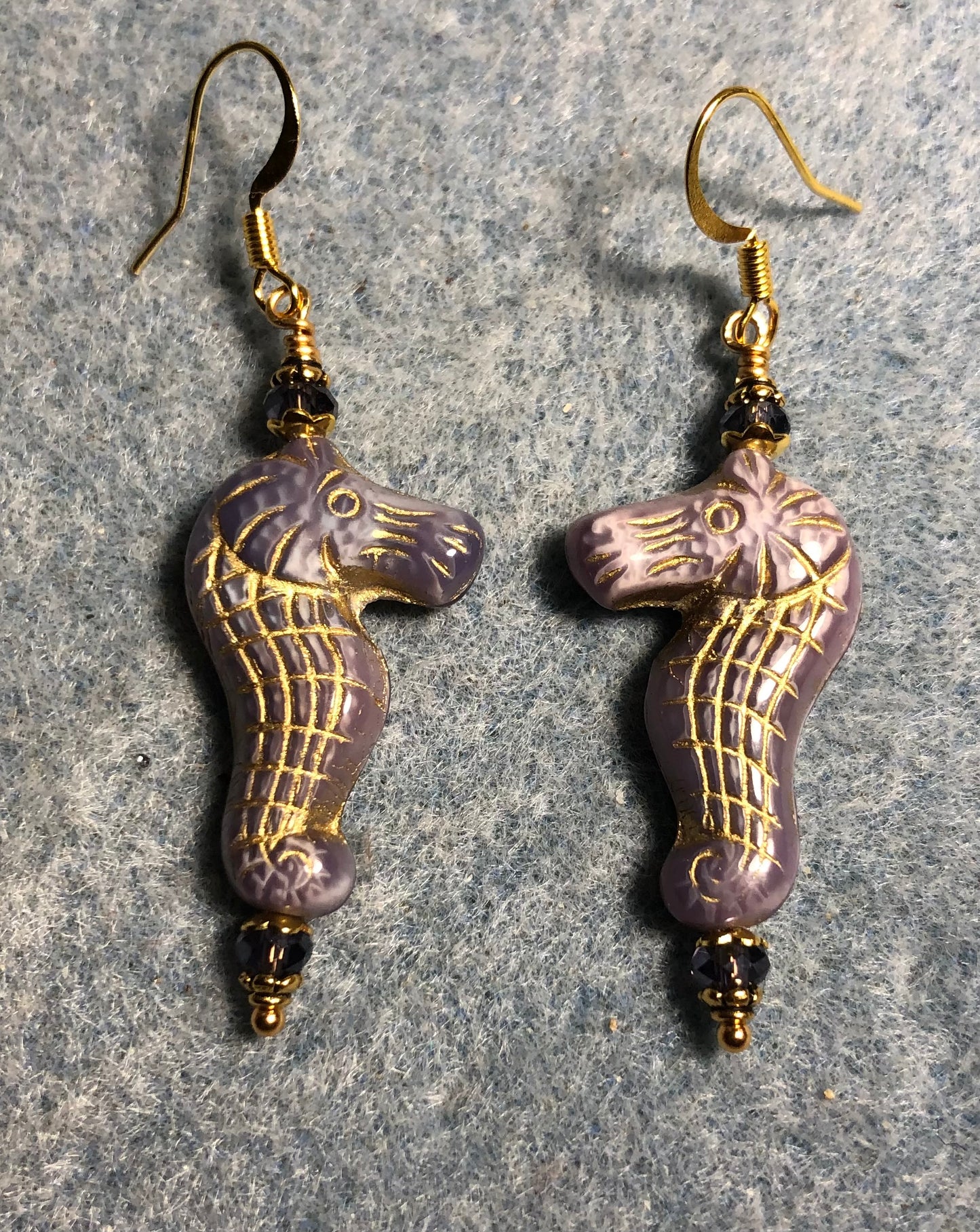 Violet (with gold inlay) Czech glass seahorse bead earrings adorned with violet Chinese crystal beads.