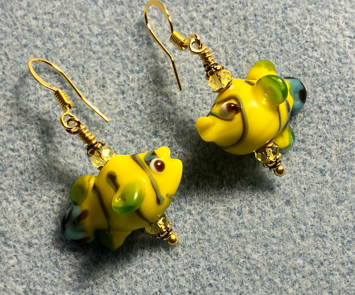 Yellow lamp work fish bead earrings adorned with yellow Chinese crystal beads.