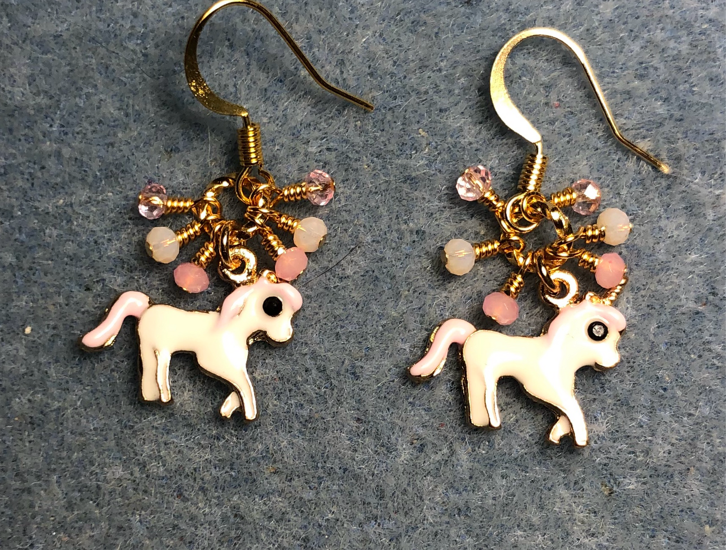 Small white and pink enamel unicorn charm earrings adorned with tiny dangling pink Chinese crystal beads.