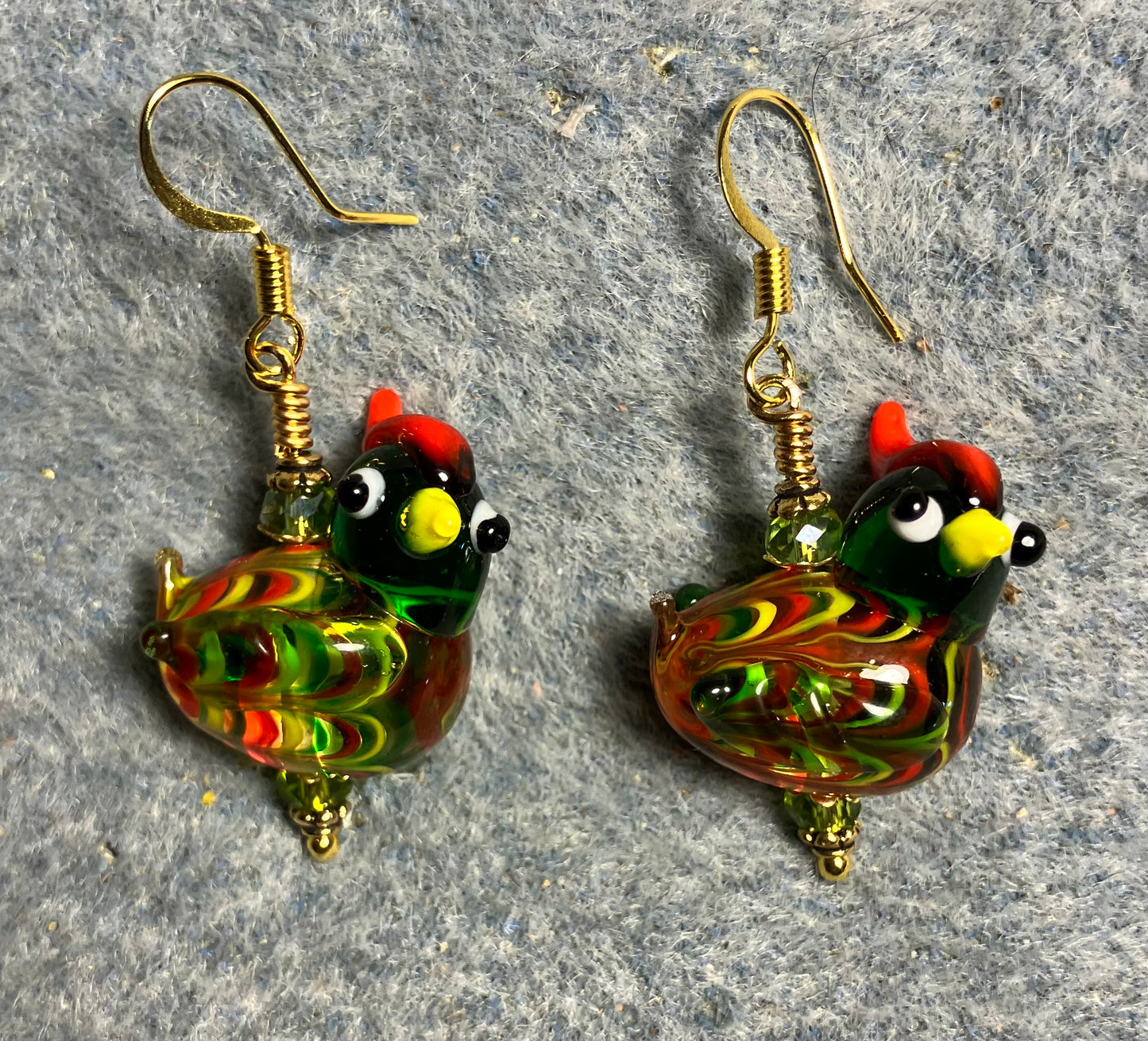 Olive green, red, and yellow lamp work mottled hen bead earrings adorned with olive green Chinese crystal beads.