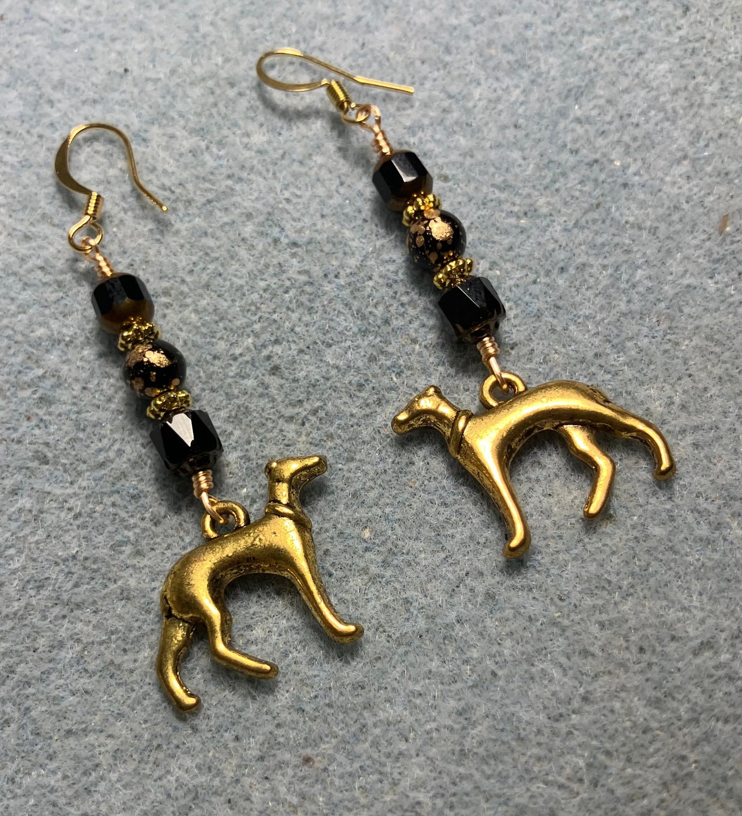Gold greyhound charm earrings adorned with black Czech glass beads