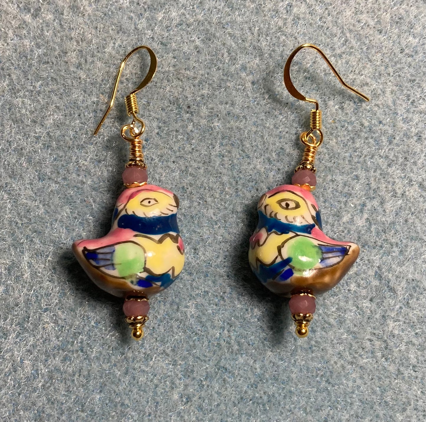 Pink, green, yellow, and blue ceramic chicken bead earrings adorned with mauve Chinese crystal beads.