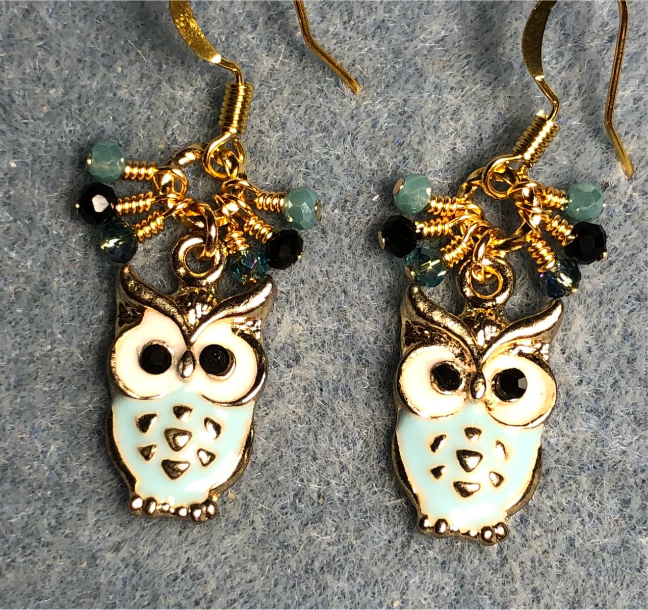 Aqua and white enamel owl charm earrings adorned with tiny dangling aqua and black Chinese crystal beads.