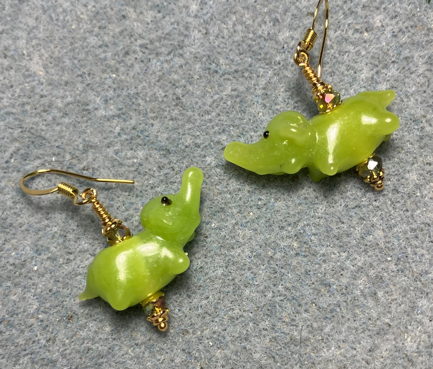 Small lime green lamp work elephant bead earrings adorned with sparkly lime green Chinese crystal beads.