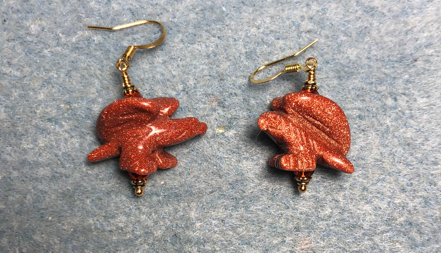 Large orange goldstone gemstone flying eagle bead earrings adorned with orange Chinese crystal beads.