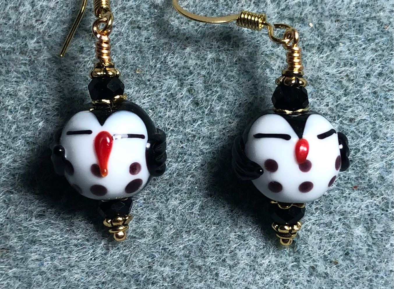 Small black and white lamp work sleepy owl bead earrings adorned with black Chinese crystal beads.