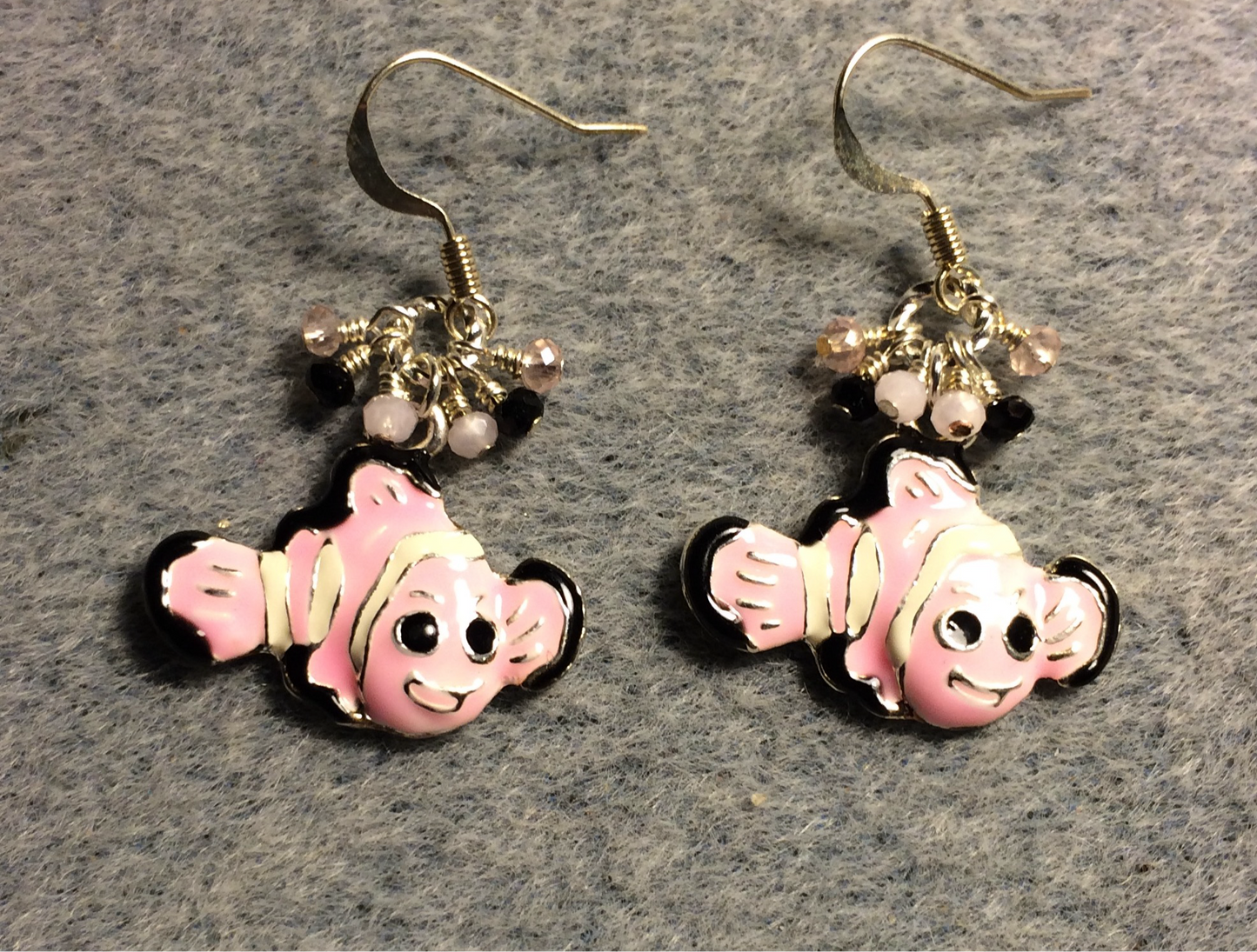 Pink, black, and white enamel striped fish charm earrings adorned with tiny dangling pink and black Chinese crystal beads.