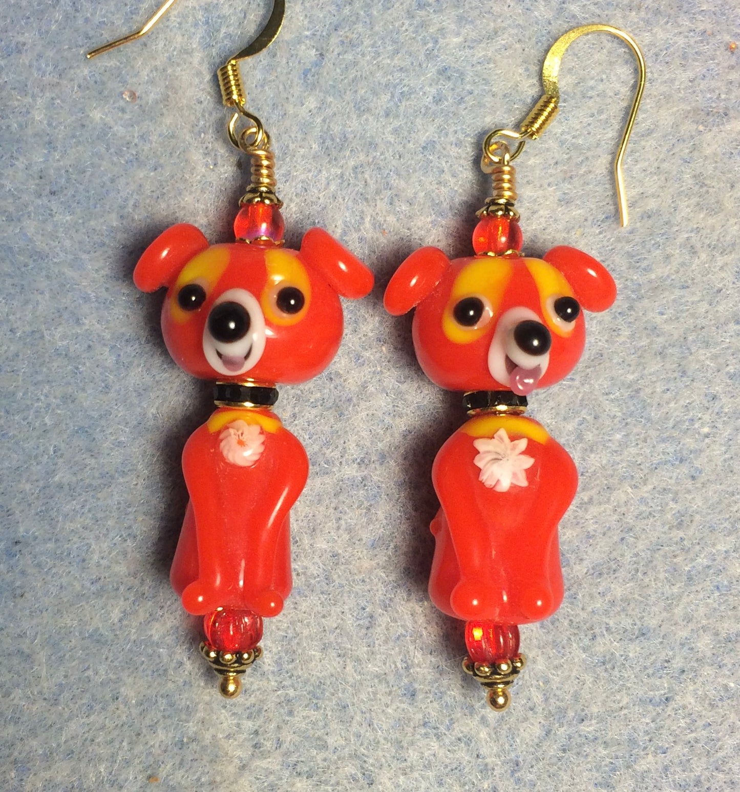 Bright red lamp work dog bead earrings adorned with black rhinestone rondelle “collars” and red Czech glass beads.